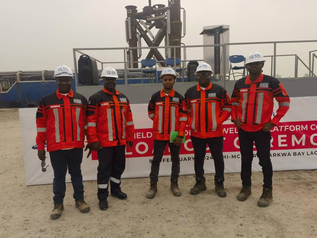 Cfi crew members in coveralls, helmets and boots.